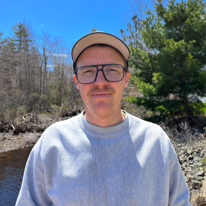 A person wearing glasses and a hat